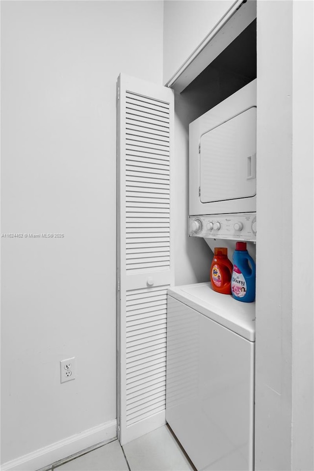 washroom featuring stacked washer / dryer