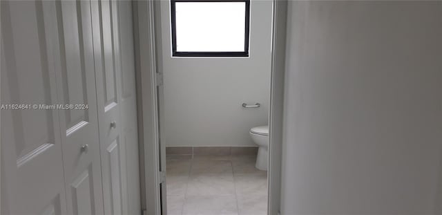 bathroom featuring toilet and tile patterned flooring