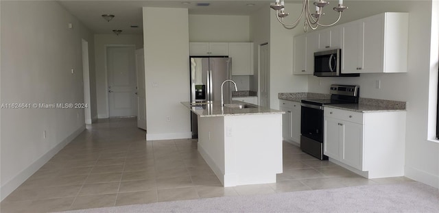 kitchen with sink, stainless steel appliances, a center island with sink, and white cabinetry