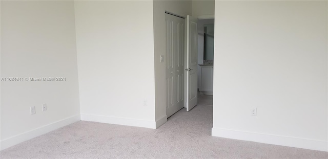 empty room featuring light colored carpet