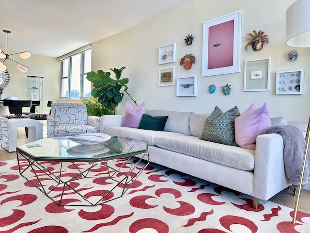 living room with light hardwood / wood-style flooring and a notable chandelier