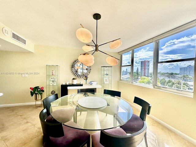 tiled dining space featuring a chandelier