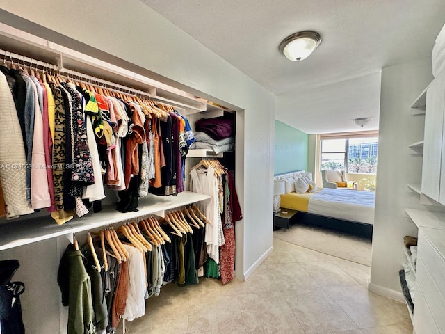 walk in closet featuring light tile patterned floors