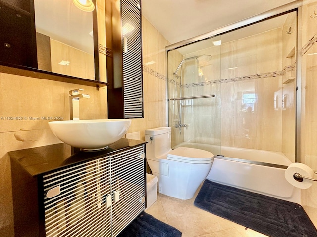 full bathroom featuring tile patterned flooring, vanity, toilet, and bath / shower combo with glass door