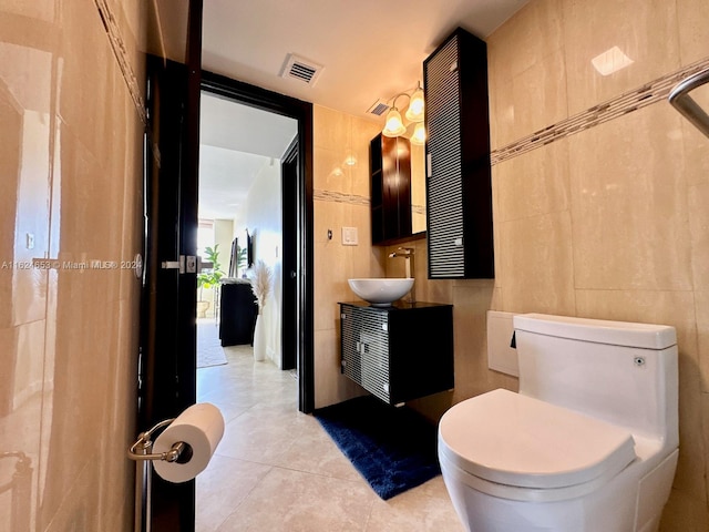 bathroom featuring tile walls, tile patterned flooring, vanity, and toilet