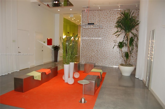 dining room with concrete flooring and track lighting