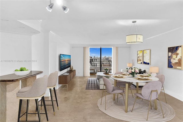 dining area featuring crown molding and floor to ceiling windows