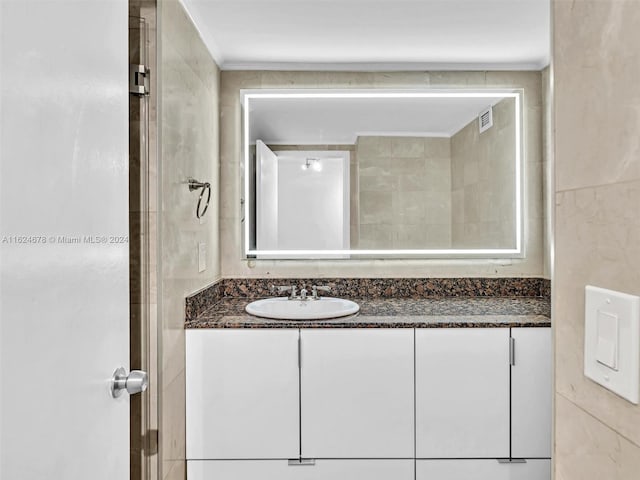 bathroom with vanity and ornamental molding