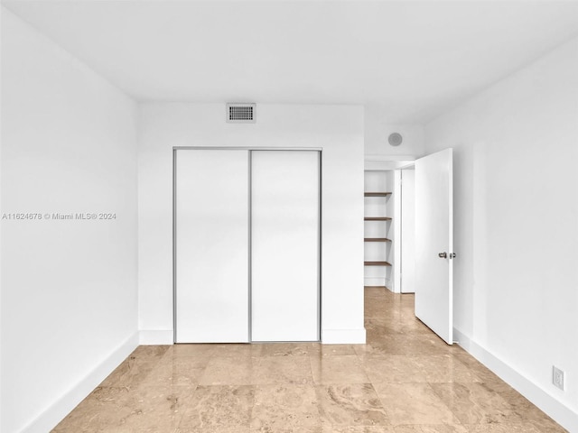 unfurnished bedroom featuring a closet