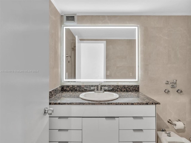 bathroom featuring vanity and tile walls