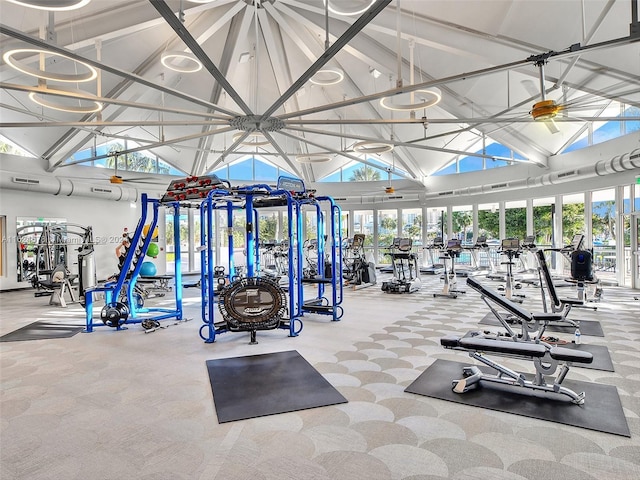 workout area with carpet floors and high vaulted ceiling