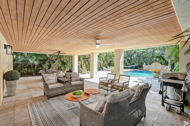 view of patio with outdoor lounge area, pool water feature, and ceiling fan