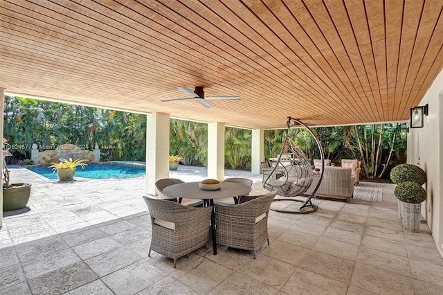 view of patio / terrace with outdoor dining area, an outdoor pool, and ceiling fan