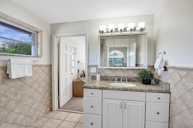 bathroom with vanity, tile patterned floors, and tile walls