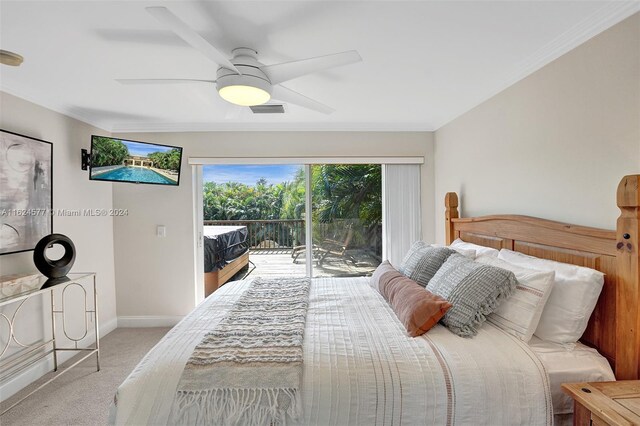 carpeted bedroom featuring access to exterior, baseboards, visible vents, ceiling fan, and ornamental molding