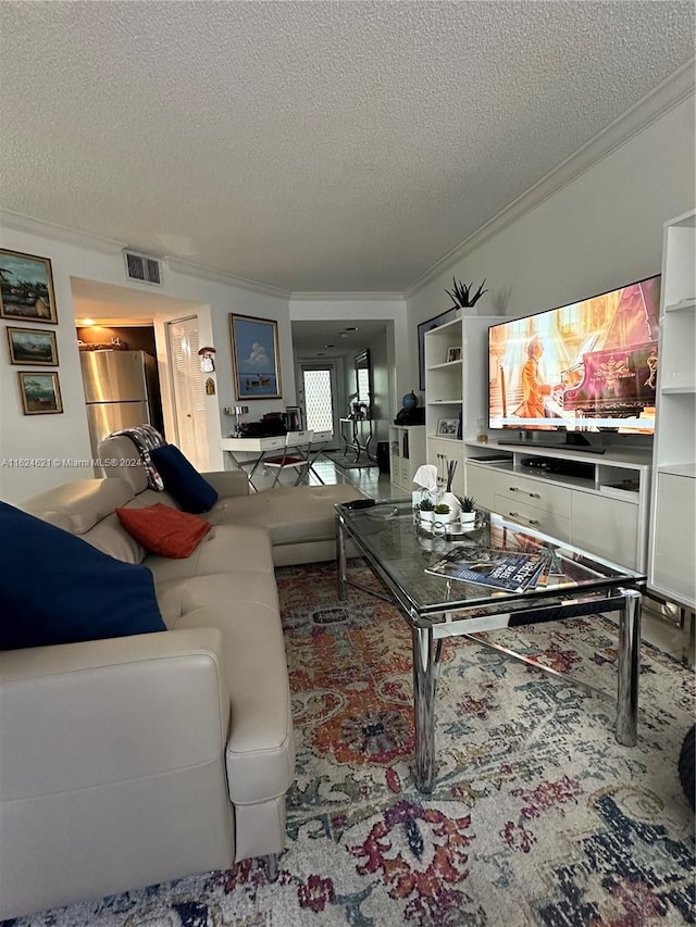 living room featuring a textured ceiling and ornamental molding