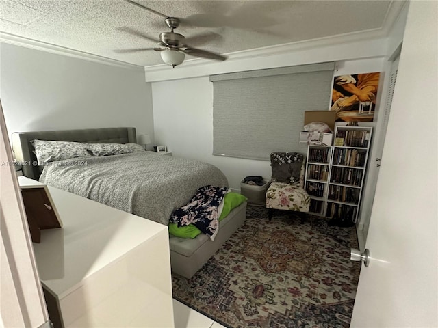 bedroom with a textured ceiling, ornamental molding, and ceiling fan