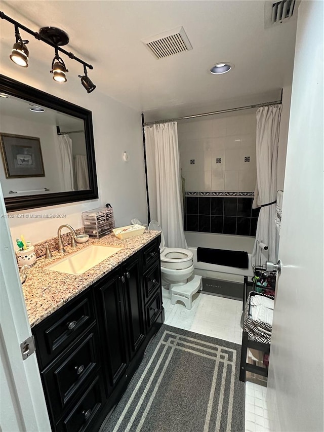 full bathroom featuring vanity, tile patterned floors, shower / tub combo, and toilet