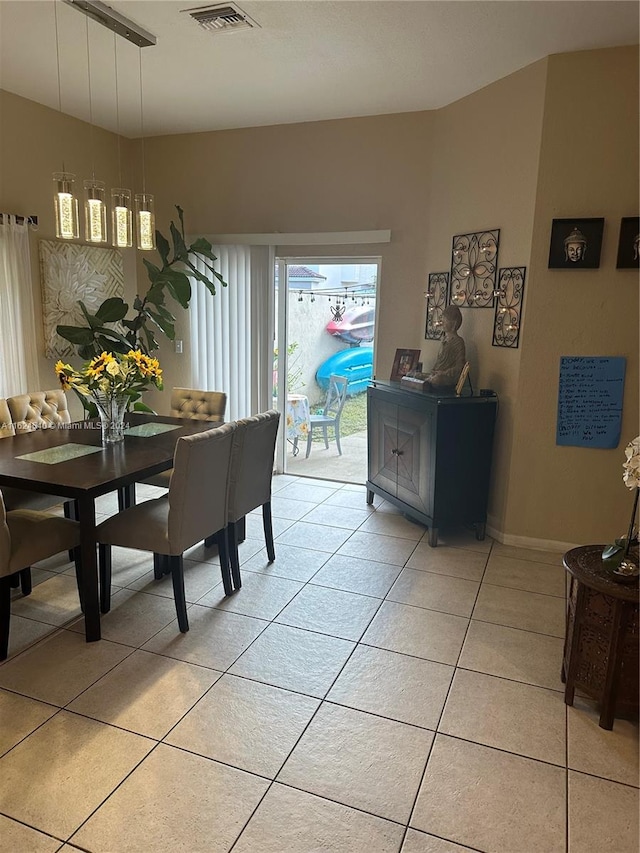 dining space featuring light tile patterned floors