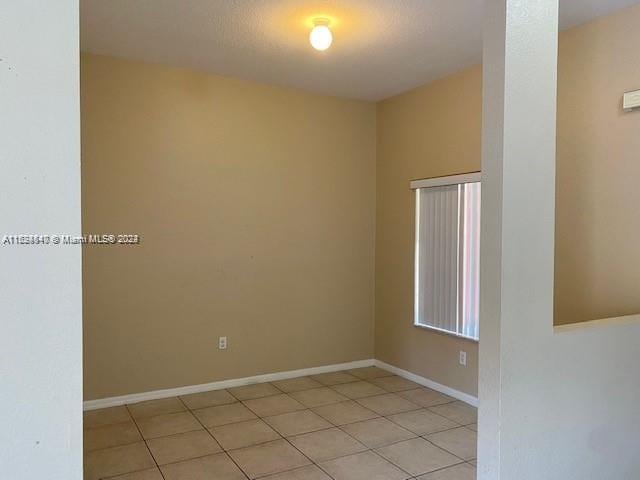 spare room with light tile patterned floors