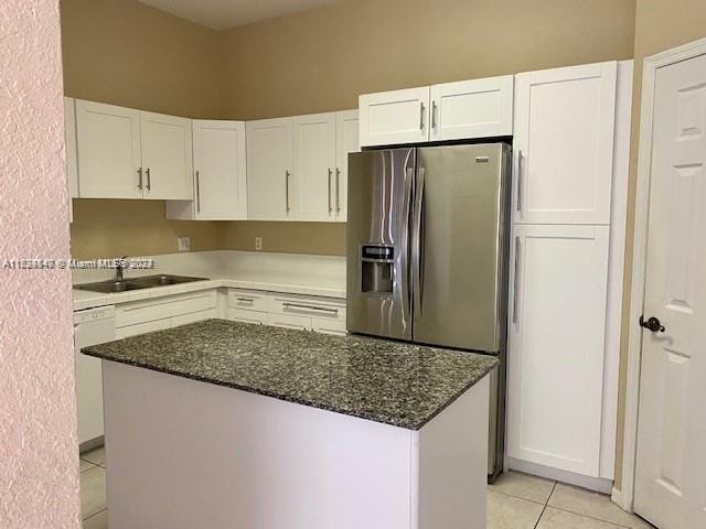 kitchen featuring a center island, sink, and white cabinets