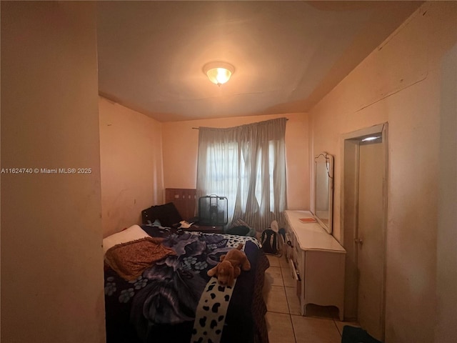 bedroom featuring light tile patterned floors