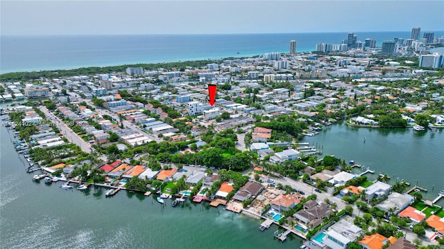 drone / aerial view featuring a view of city and a water view