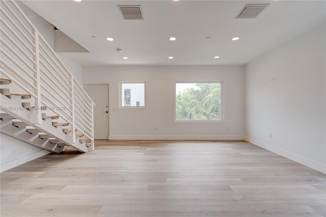 kitchen with appliances with stainless steel finishes and light hardwood / wood-style floors