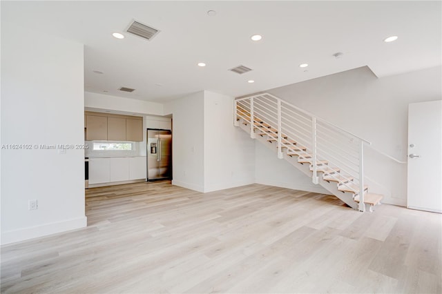 unfurnished living room with light wood finished floors, recessed lighting, visible vents, stairway, and baseboards