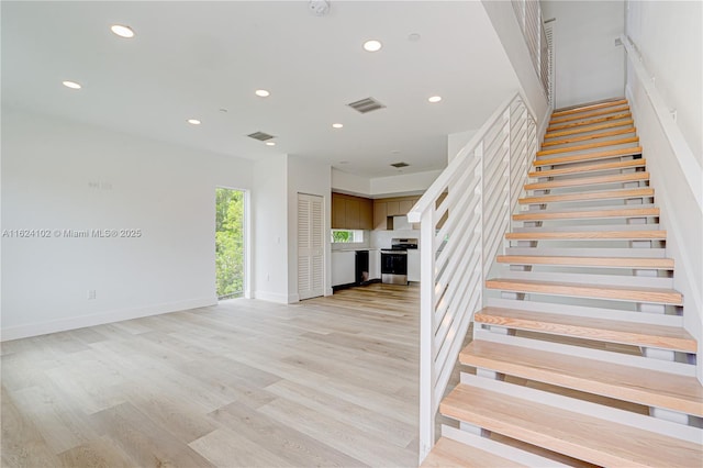 stairs featuring hardwood / wood-style flooring