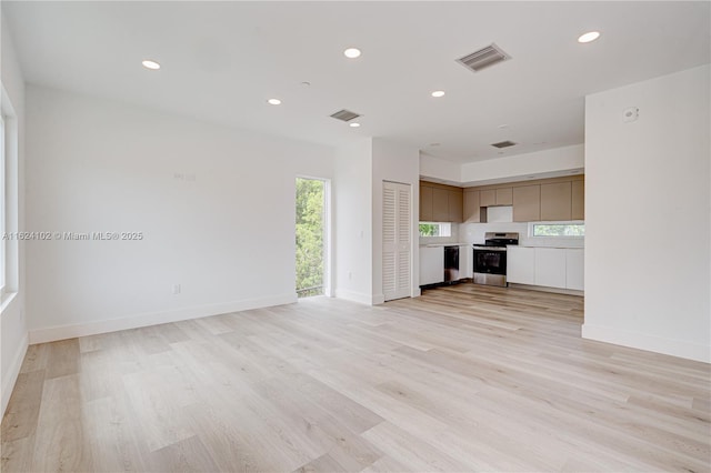 unfurnished living room featuring recessed lighting, visible vents, and light wood-style floors