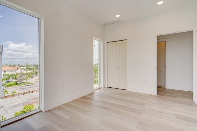 unfurnished room with light hardwood / wood-style floors