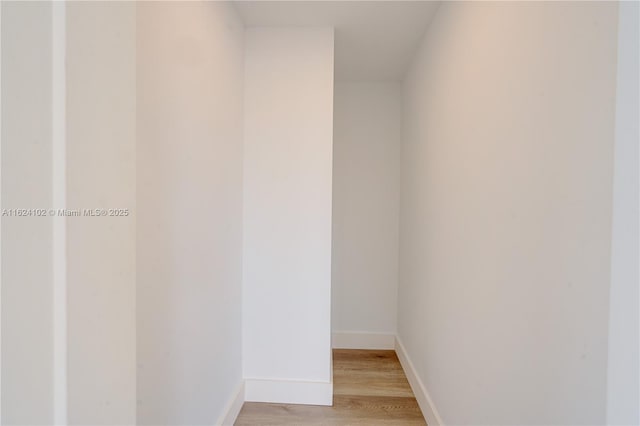 interior space featuring baseboards and light wood-style floors