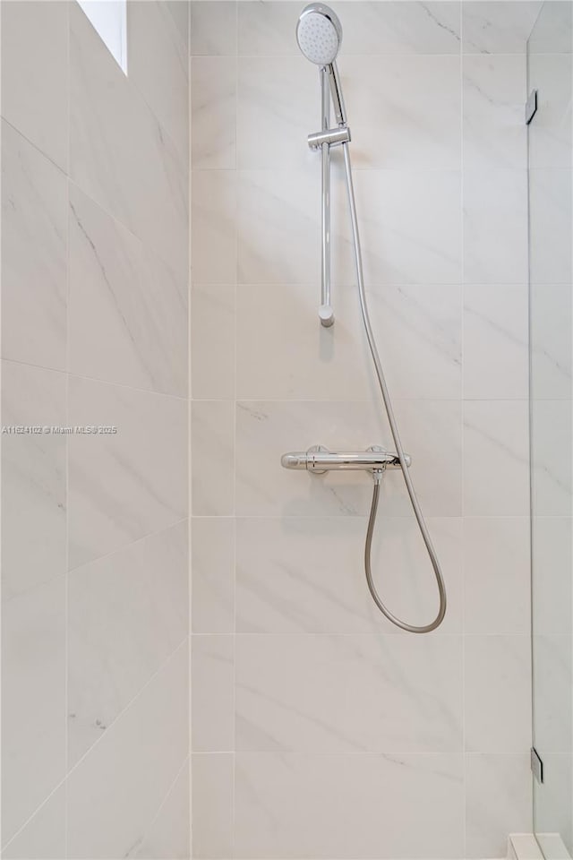 bathroom with tiled shower