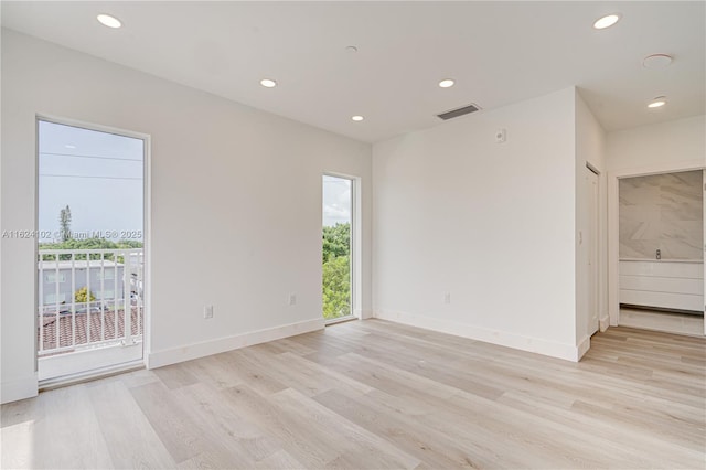 empty room featuring recessed lighting, visible vents, light wood-style flooring, and baseboards