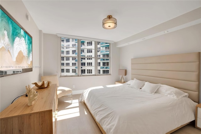 bedroom featuring multiple windows and light wood-type flooring