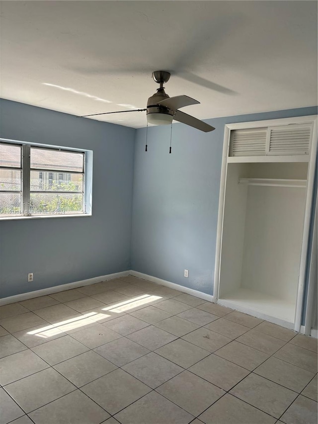 unfurnished bedroom featuring light tile patterned floors, a closet, and ceiling fan