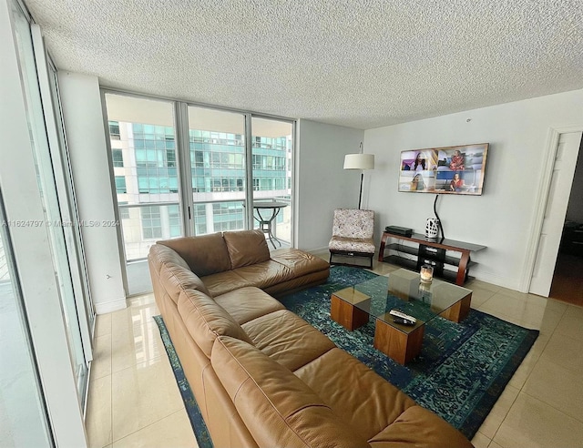 living room featuring a wall of windows, light tile patterned floors, and a textured ceiling