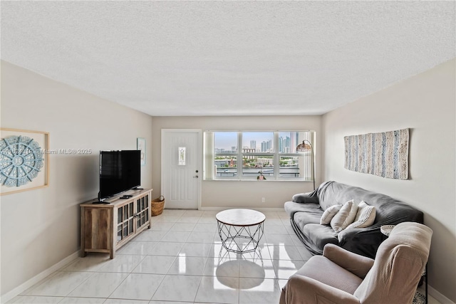 living room with light tile patterned flooring and a textured ceiling