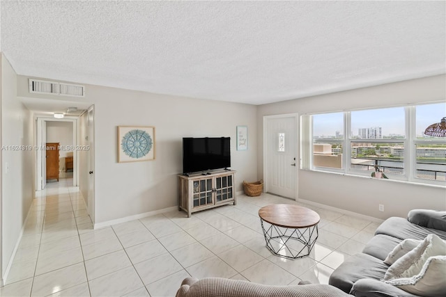 living room featuring light tile patterned floors and a textured ceiling