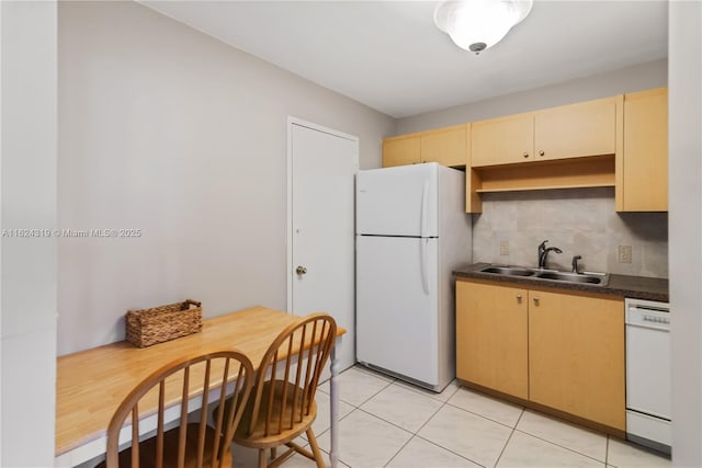 kitchen featuring light brown cabinetry, backsplash, white appliances, sink, and light tile patterned floors