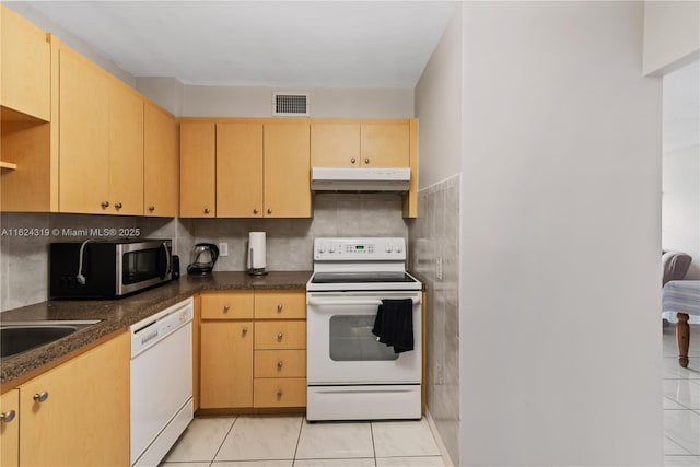 kitchen featuring light tile patterned floors, white appliances, sink, and light brown cabinetry