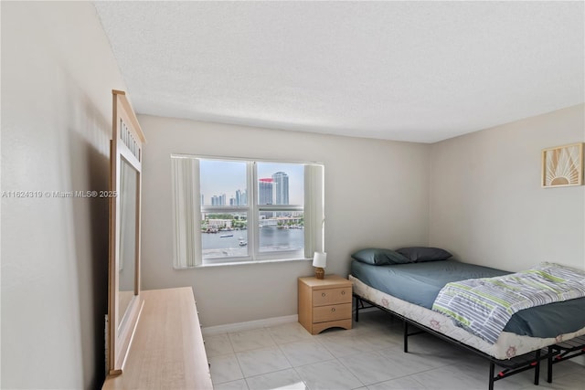 tiled bedroom featuring a textured ceiling