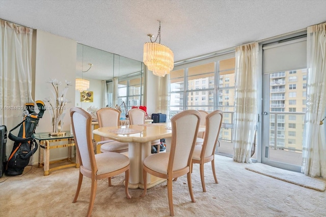 carpeted dining area with expansive windows, a textured ceiling, and a chandelier