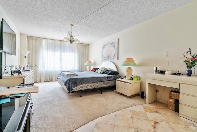 carpeted bedroom with a textured ceiling and an inviting chandelier