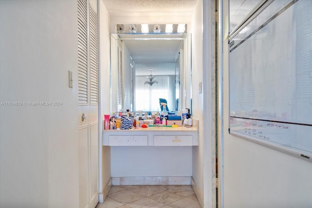 bathroom featuring a textured ceiling and vanity