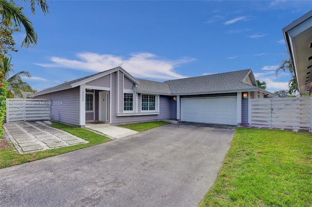 single story home with a garage and a front yard