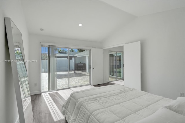 bedroom with lofted ceiling, access to outside, and light hardwood / wood-style floors