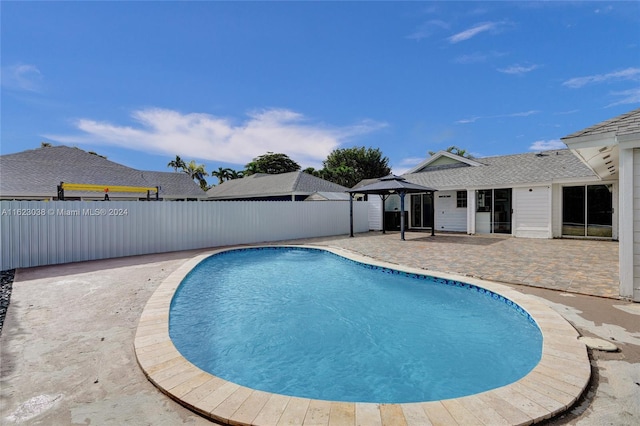 view of swimming pool featuring a gazebo and a patio area