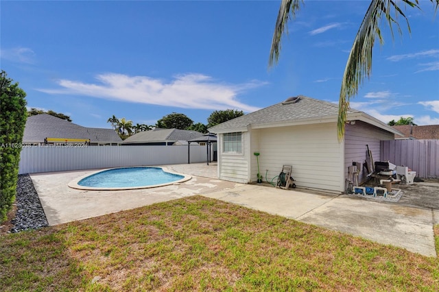 view of pool with a lawn and a patio area